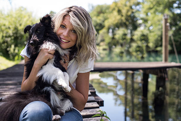 istock Young Woman With Dog At The Park 525669321