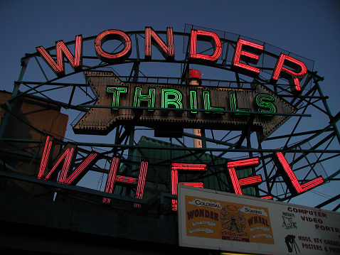 New York City, NY, USA - April 27, 2003: View of Coney Island's Wonder Wheel neon sign and billboard. Brooklyn, NY. 