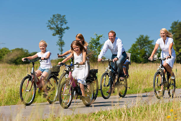 istock Family cycling outdoors in summer 525669623