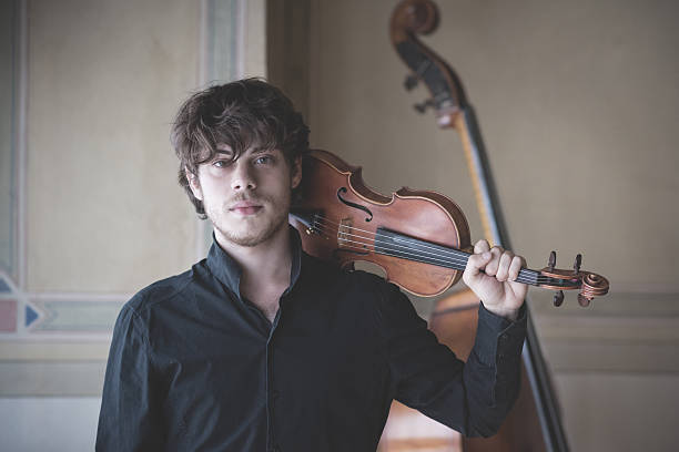 istock young handsome blonde violinist 525671407