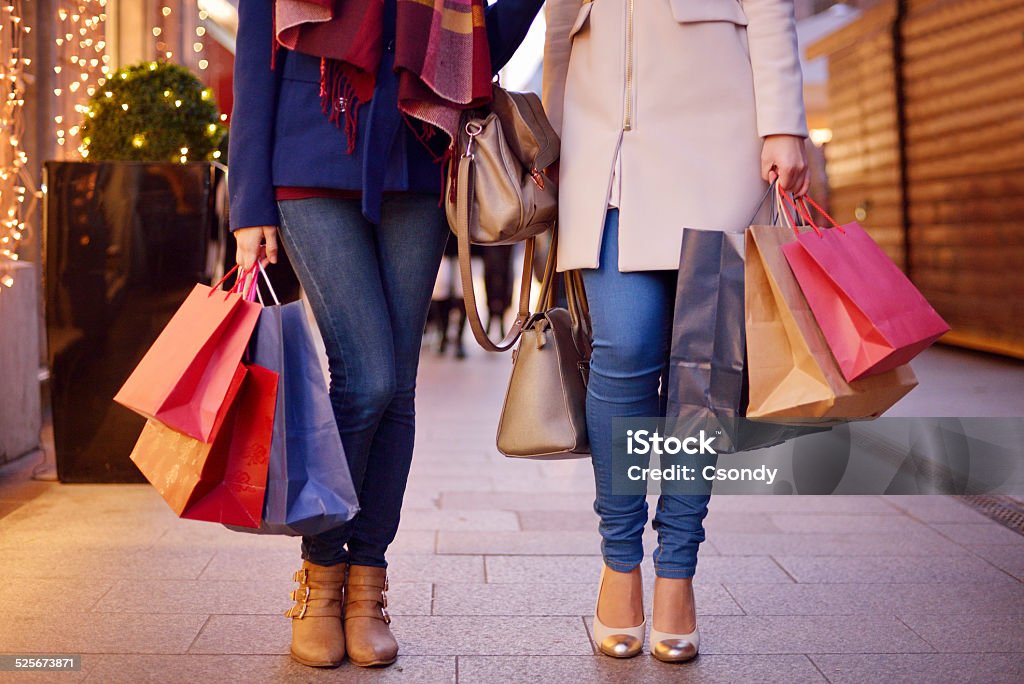 Shopping Young women shopping in the city, legs and hands close up, carrying paper bags. Shopping Bag Stock Photo