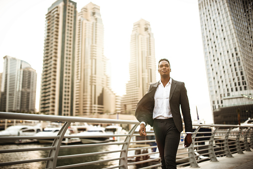 Businessman walking in dubai marina