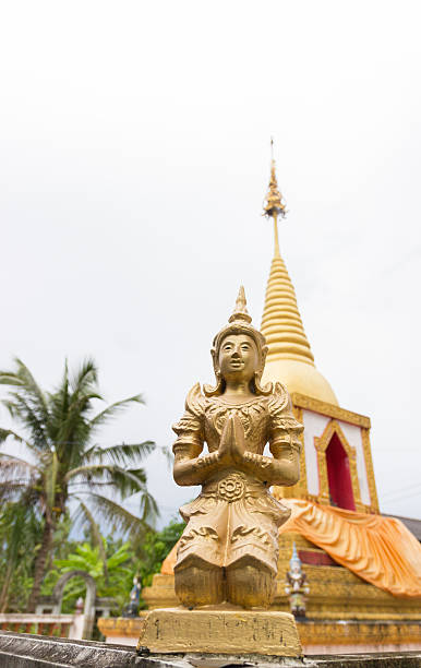 istock praying angel statue beside the buddhist pagoda 525674381