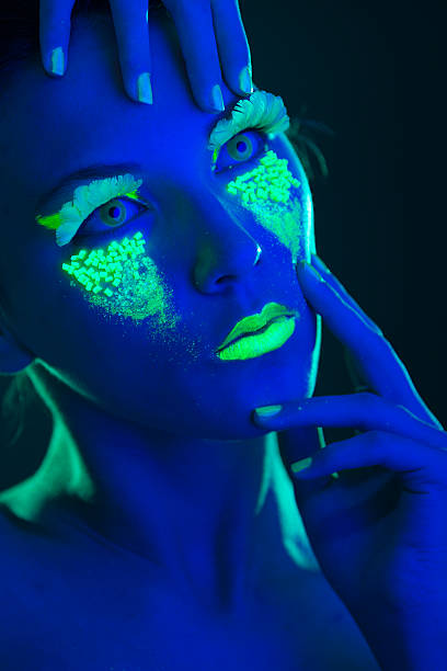 istock Woman Portrait painted with UV makeup color 525674869