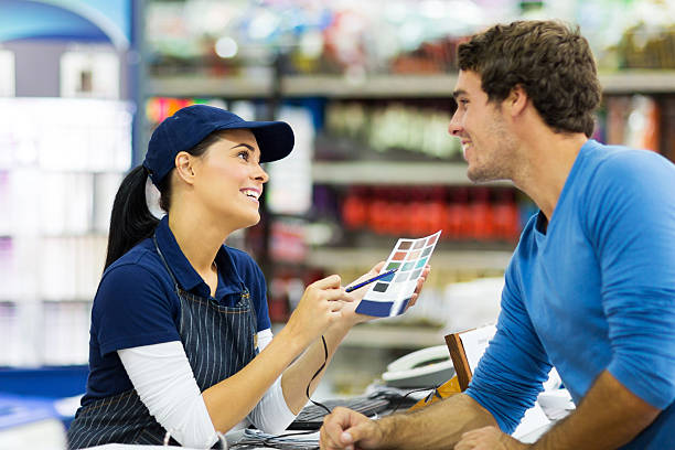 istock female paint store worker talking to customer 525675227