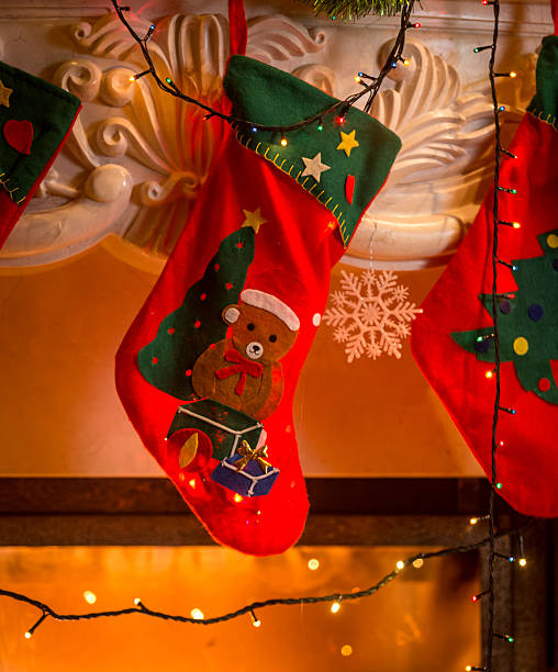 istock red christmas stockings hanging on fireplace 525675307