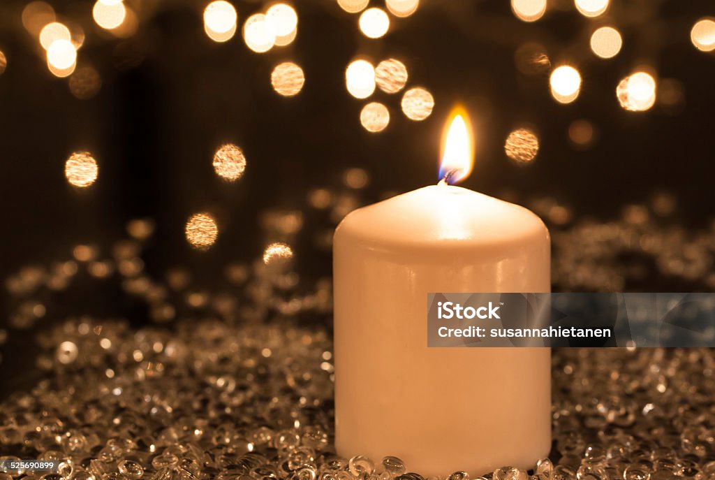 White candle and decorative lights White candle and decorative festive lights Candle Stock Photo