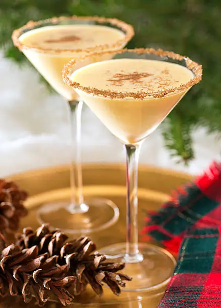 Two delicious eggnog martinis with brown sugar rimmer and cinnamon sprinkle.