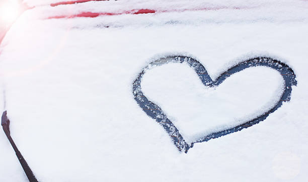 istock Snow heart on the car window 525694253