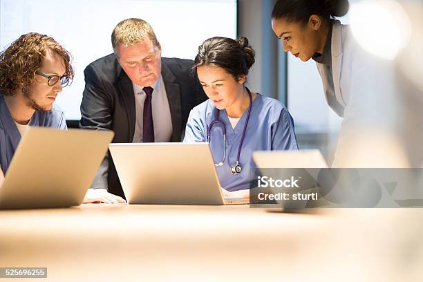 Hospital Team Debrief Stock Photo - Download Image Now - Healthcare And Medicine, Meeting, 30-39 Years