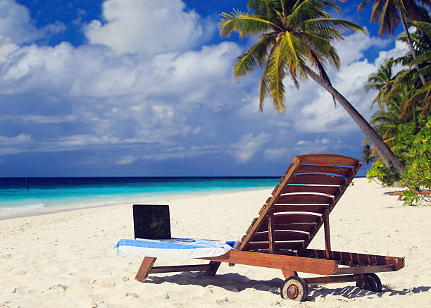 istock laptop on chair in tropical vacation 525713271
