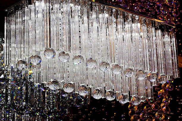 istock Contemporary glass chandelier isolated over black background 525714433