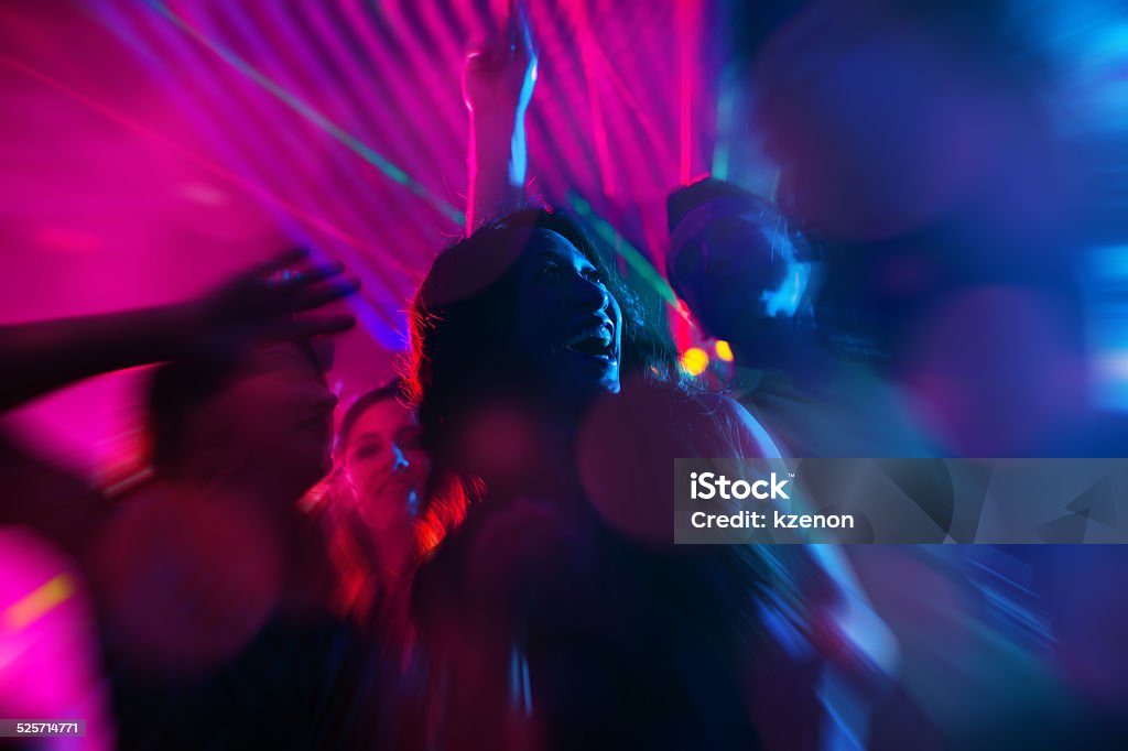Party people dancing in disco or club Group of party people - a man and women - dancing in a disco club to the music Nightclub Stock Photo