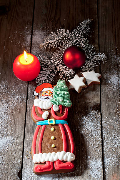 istock Gingerbread santa claus, cinnamon stars, wooden floor 525715575