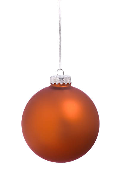 istock Christmas holiday orange tree ornament bauble isolated on white 525715893