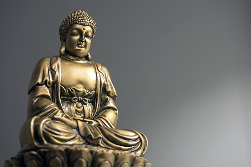 Golden statuette of India-style sitting Buddha