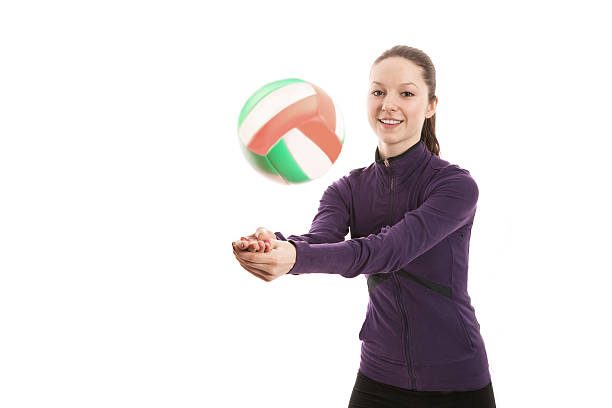 istock Smiling young woman playing volleyball 525718317
