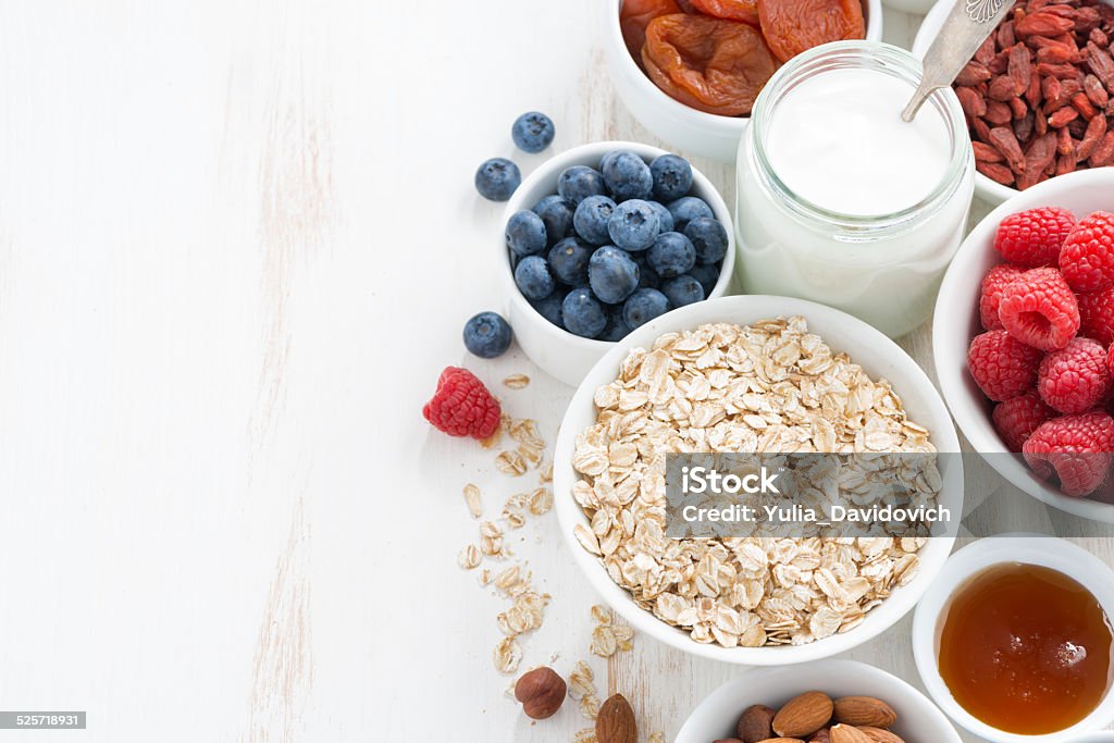 cereal and various delicious ingredients for breakfast cereal and various delicious ingredients for breakfast and white wooden background, top view Backgrounds Stock Photo