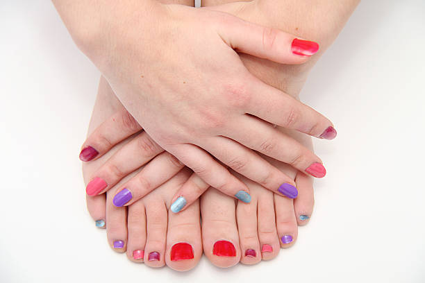 istock Women's hands and legs with a colored nails 525718959