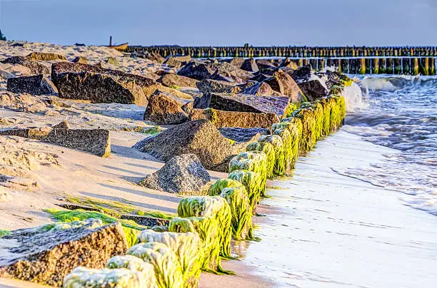 Wooden and rocky groynes on the coastline of the Baltic Sea, Germany