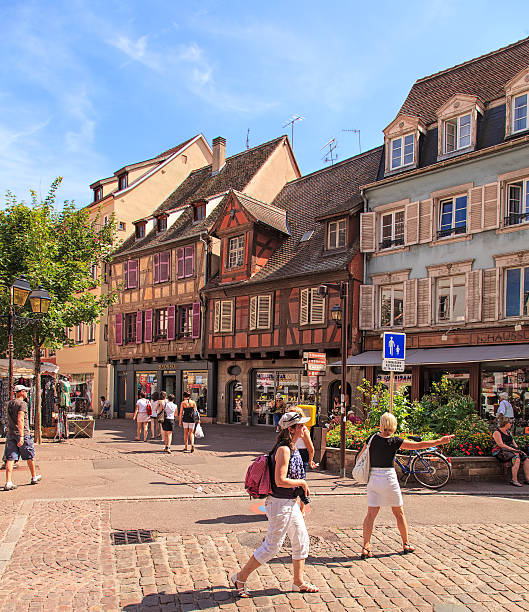 Colmar, France - 18 July, 2014: stores and people in the old town. Colmar is the third-largest commune of the Alsace region in north-eastern France, renowned for its well preserved old town, numerous architectural landmarks and museums.