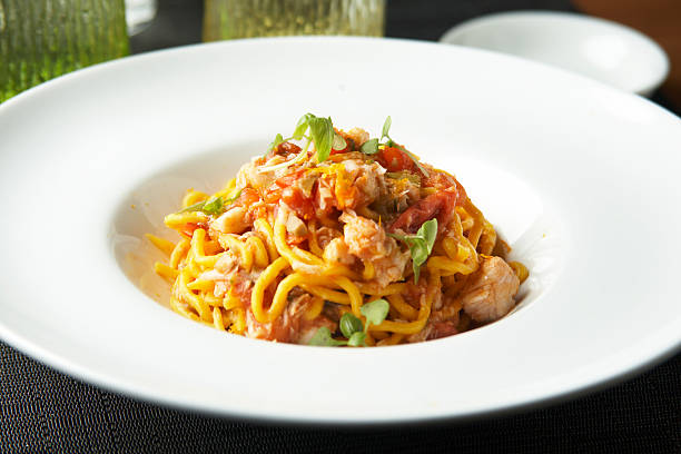 istock Fresh spaghetti with white fish ragout, capers and orange zest 525728260