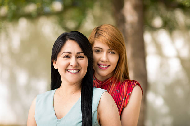 istock Beautiful latin mother and daughter smiling 525729250