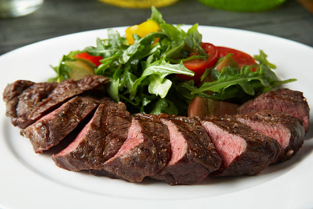 istock layered beef loin with vegetables and greens salad 525729392