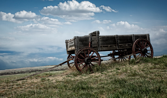 This is a historical photo of an abandoned wagon out on the Wyoming prairie