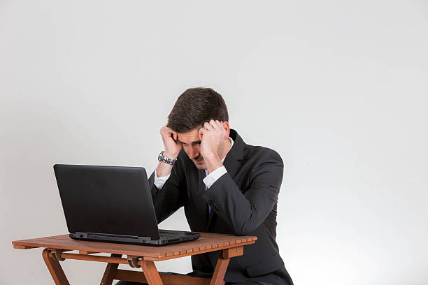istock Business man is sitting desperate on a laptop 525733920