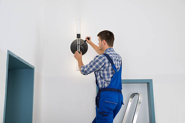 Electrician Repairing Light Male Electrician Standing On Stepladder Repairing Light caretaker stock pictures, royalty-free photos & images