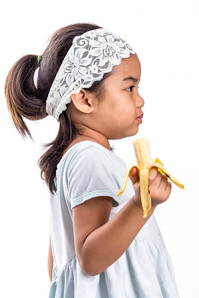 istock Girl Holding Banana 525734873