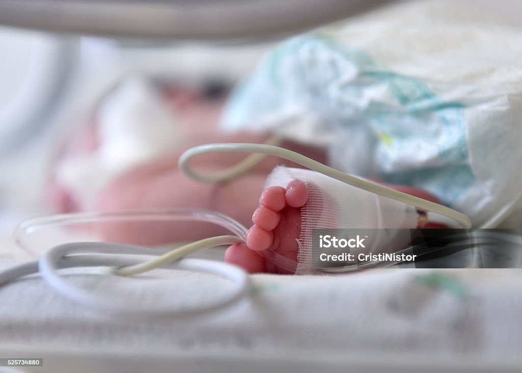 Newborn baby Newborn baby with cannula in the feet on a hospital bed Baby - Human Age Stock Photo
