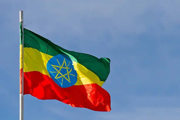 Ethiopia flag is waving in front of blue sky