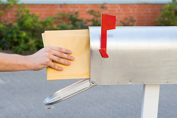 istock Person Putting Letters In Mailbox 525735436