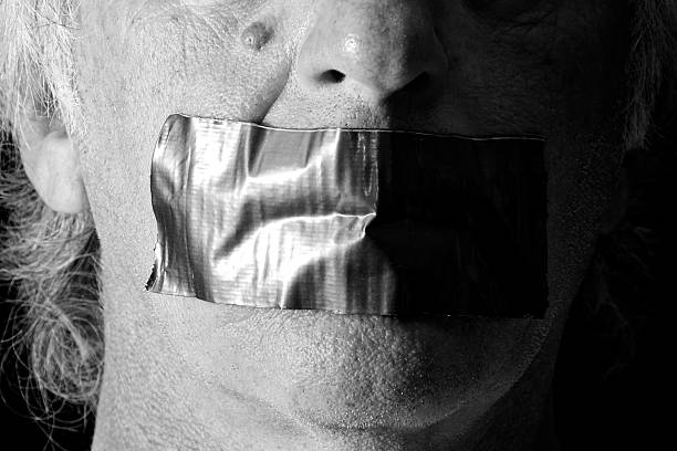istock black and white mouth duct taped shut 525735998