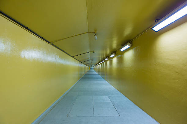 Yellow empty pedestrian tunnel passing under the Creek and connecting Deira District with the new district in Dubai. United Arab Emirates 2016