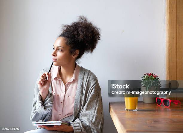 Young Woman Sitting At Home With Pen And Paper Stock Photo - Download Image Now - Contemplation, Women, Writing - Activity