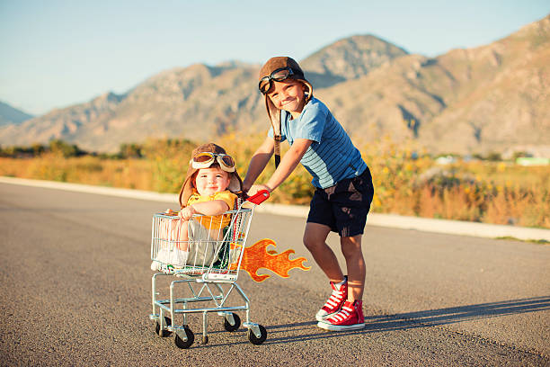 istock Two Young Boys Racing Shopping Cart 525737502