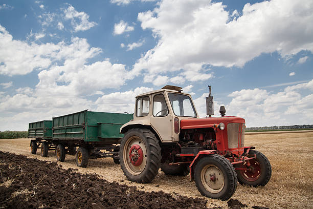 istock old tractor in field, against a cloudy sky 525737671