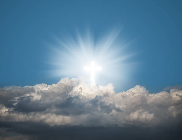 istock Glowing holy cross in the blue  sky 525737954