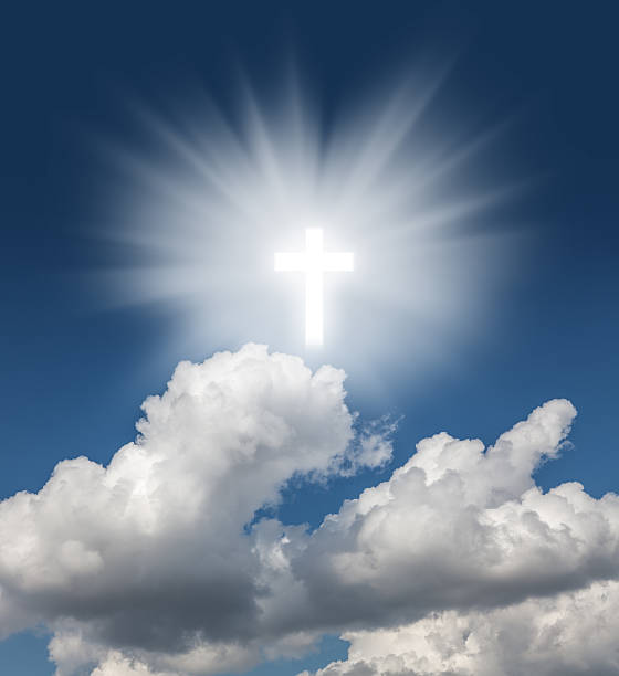 istock Glowing holy cross in the blue  sky 525738038