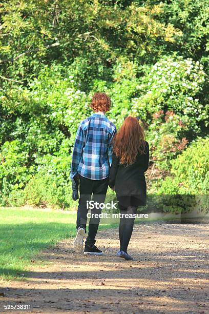 Boy And Girl Walking Along Woodland Pathway Footpath Holdinghands Redhair Stock Photo - Download Image Now