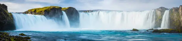 The turquoise waters of the Skjálfandafljót river cascading over the spectacular Godafoss waterfalls in the Arctic north of Iceland. ProPhoto RGB profile for maximum color fidelity and gamut.