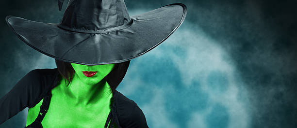Beautiful witch with green skin stock photo