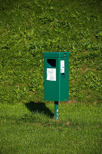 istock Close up of bright green dog bin with label. 525741055