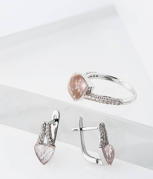 istock White gold ring and an earrings collection with rose quartz 525751541