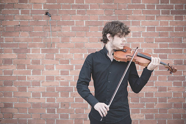 istock young handsome blonde violinist 525751923