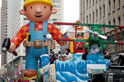 Philadelphia, PA, USA - November 27, 2014: Recording artist Sheena Easton is seen waving as she stands on one of the floats participating in the Philadelphia Thanksgiving Day Parade. Seen in the background is a Bob the Builder ballon.