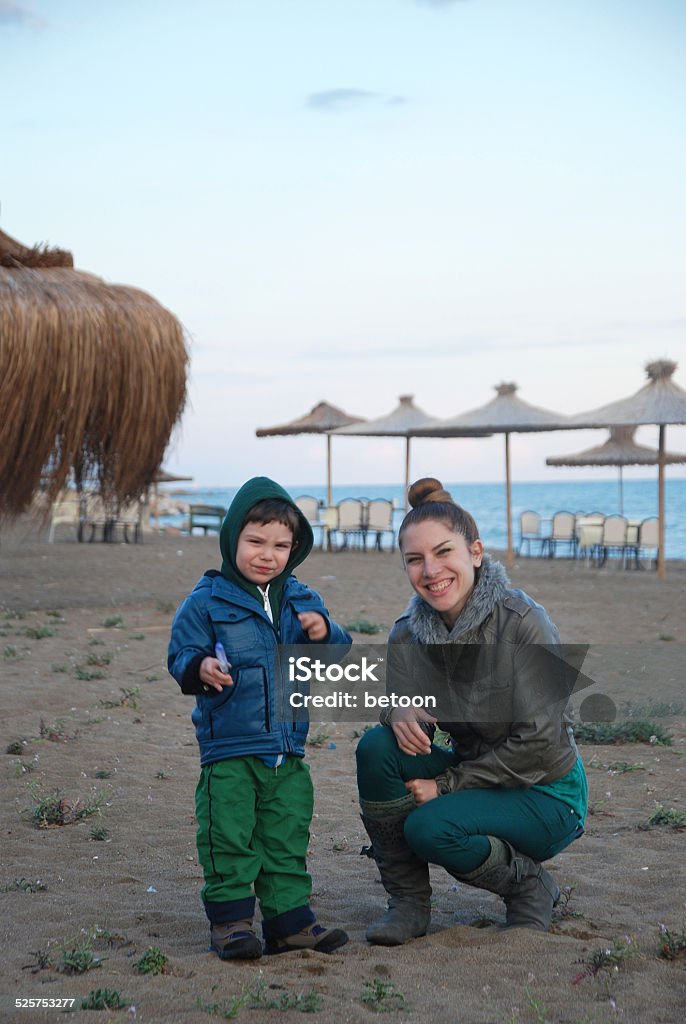 Winter on the Beach A Turkish family is enjoying a not so cold winter day by walking on the lonely beach of Pompei. Location is Mezitli , Turkey . 2-3 Years Stock Photo